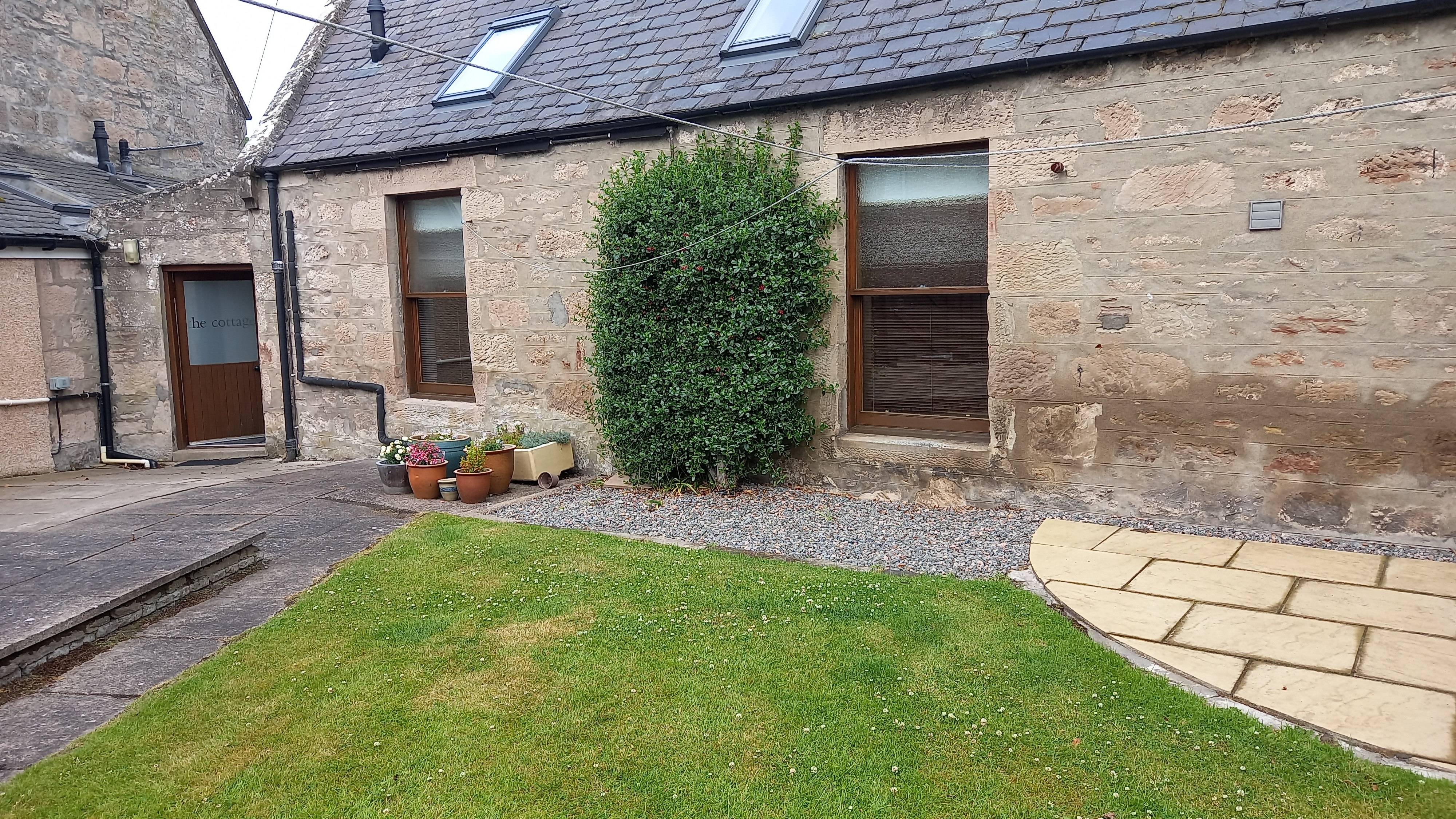 Garden with cottage door, living room and double bedroom windows